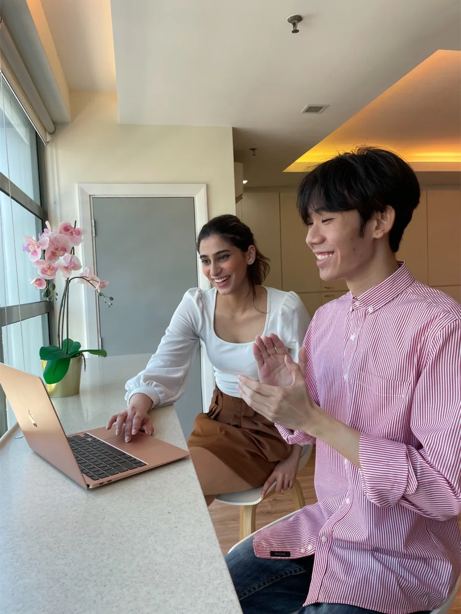 PROTÉGÉ graduates working together on a laptop