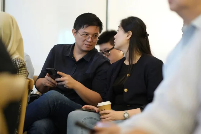 Guests comparing notes during the keynote