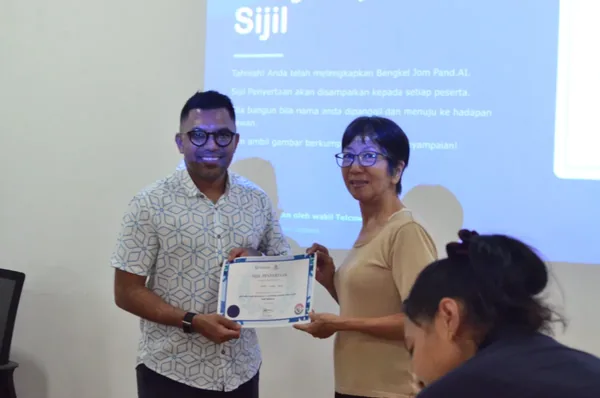 A participant receiving their certificate of completion