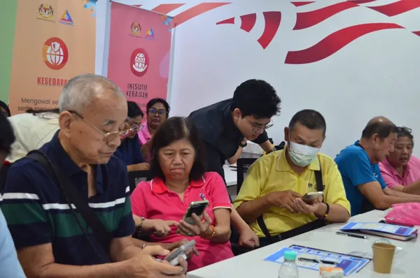 Participants practising on their phones during the workshop